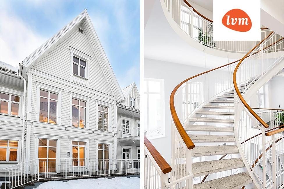 a white house and a staircase in front of it at Villa Lehe Ranna Apartment in Pärnu
