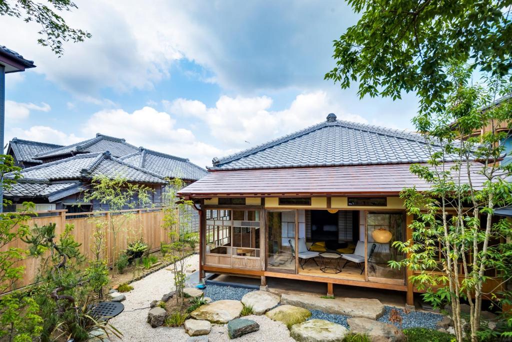 a small house with a garden and a fence at NIPPONIA Sawara Merchant Town Hotel in Katori