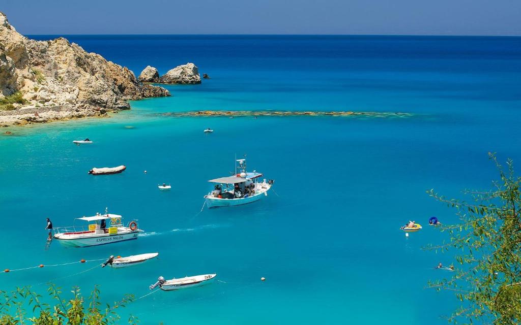 a group of boats in a large body of water at Av Apartment in Agios Nikitas