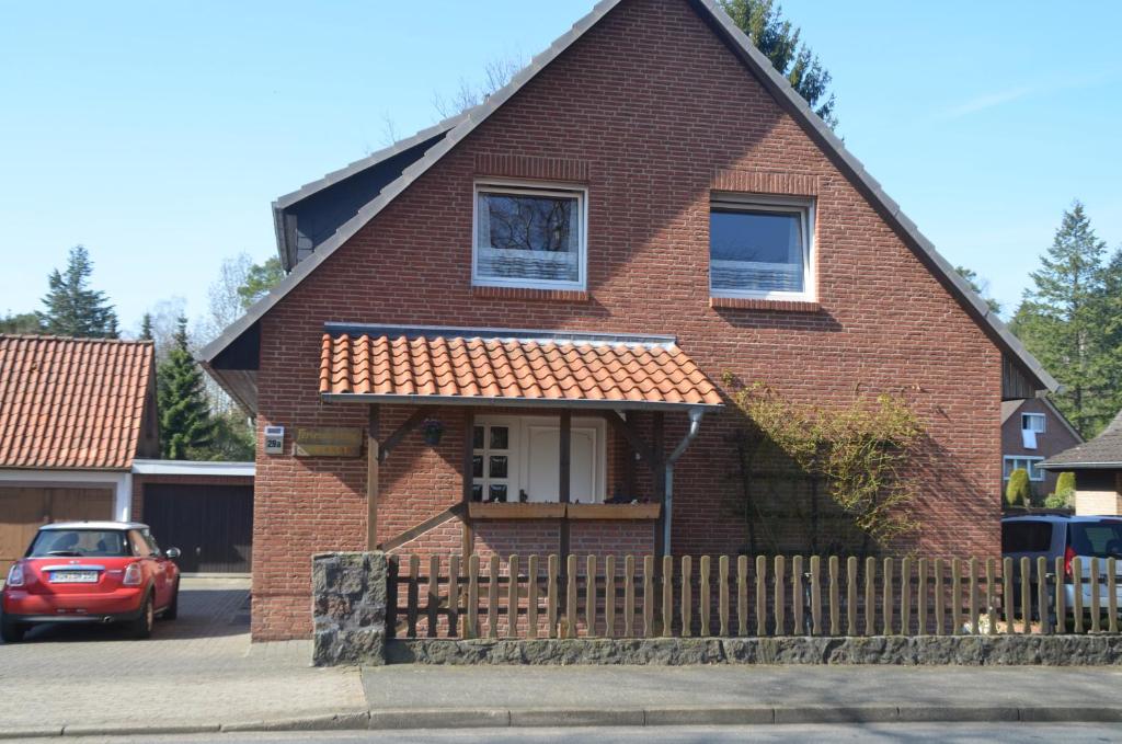 a red brick house with a red roof at Ferienwohnung Grensemann in Schneverdingen
