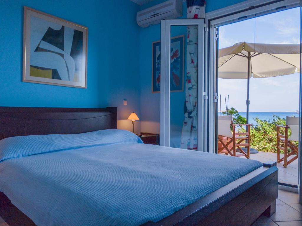 A bed or beds in a room at Kounopetra Beach Luxury Villas