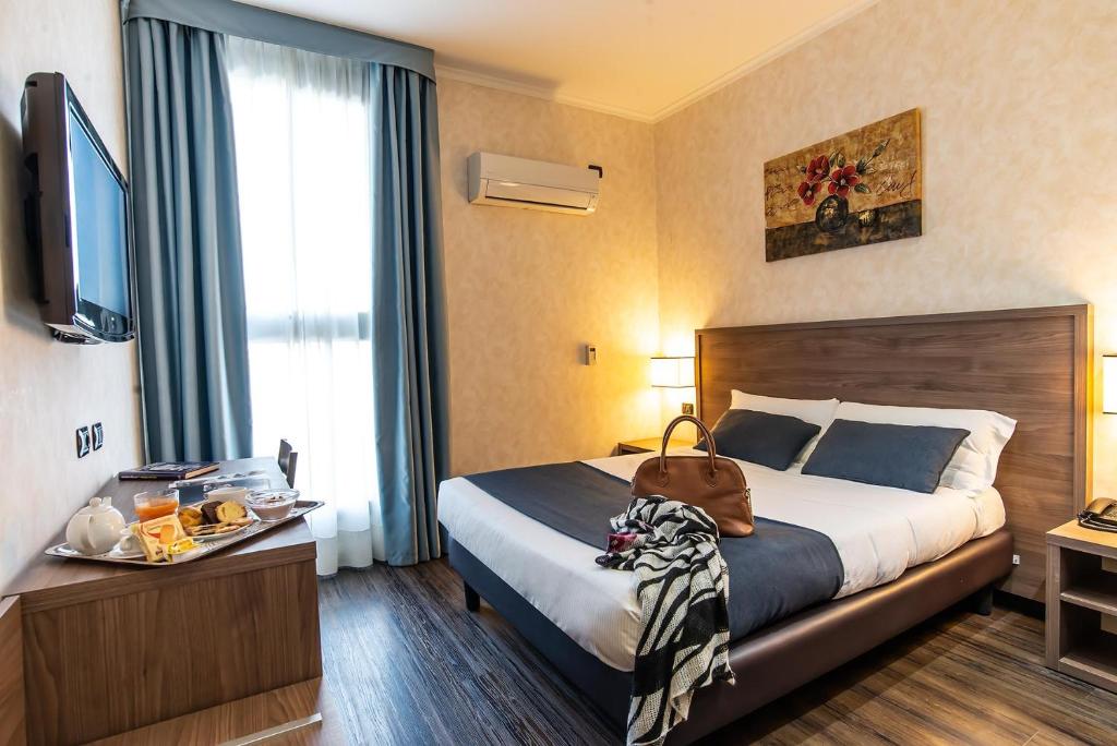 Postel nebo postele na pokoji v ubytování Hotel Roma Sud
