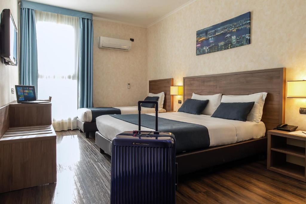 Postel nebo postele na pokoji v ubytování Hotel Roma Sud