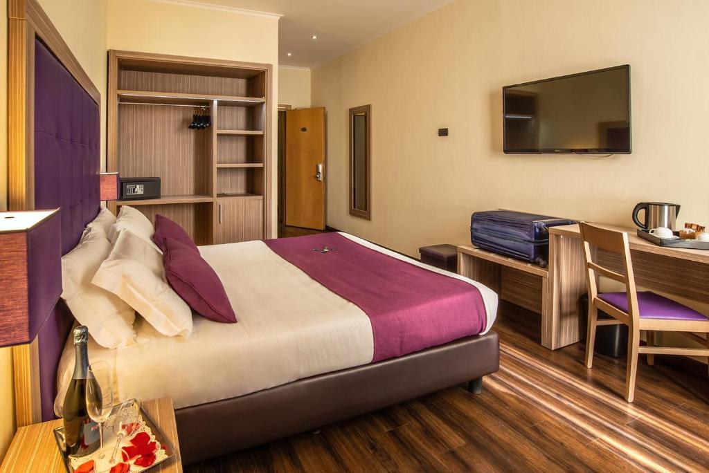 Postel nebo postele na pokoji v ubytování Hotel Roma Sud