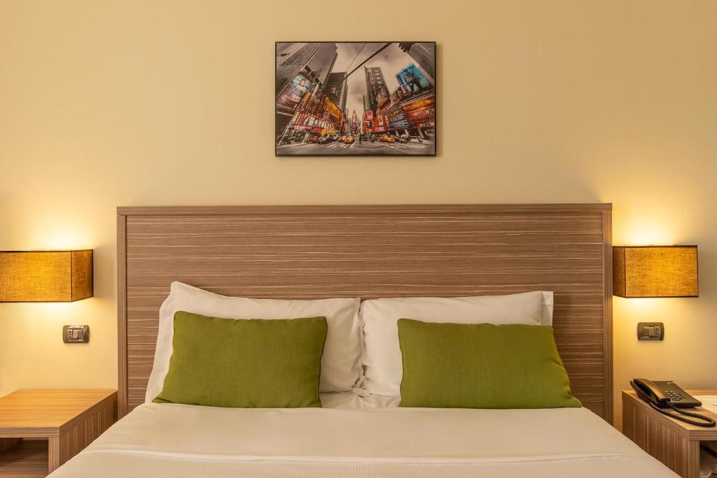 Postel nebo postele na pokoji v ubytování Hotel Roma Sud