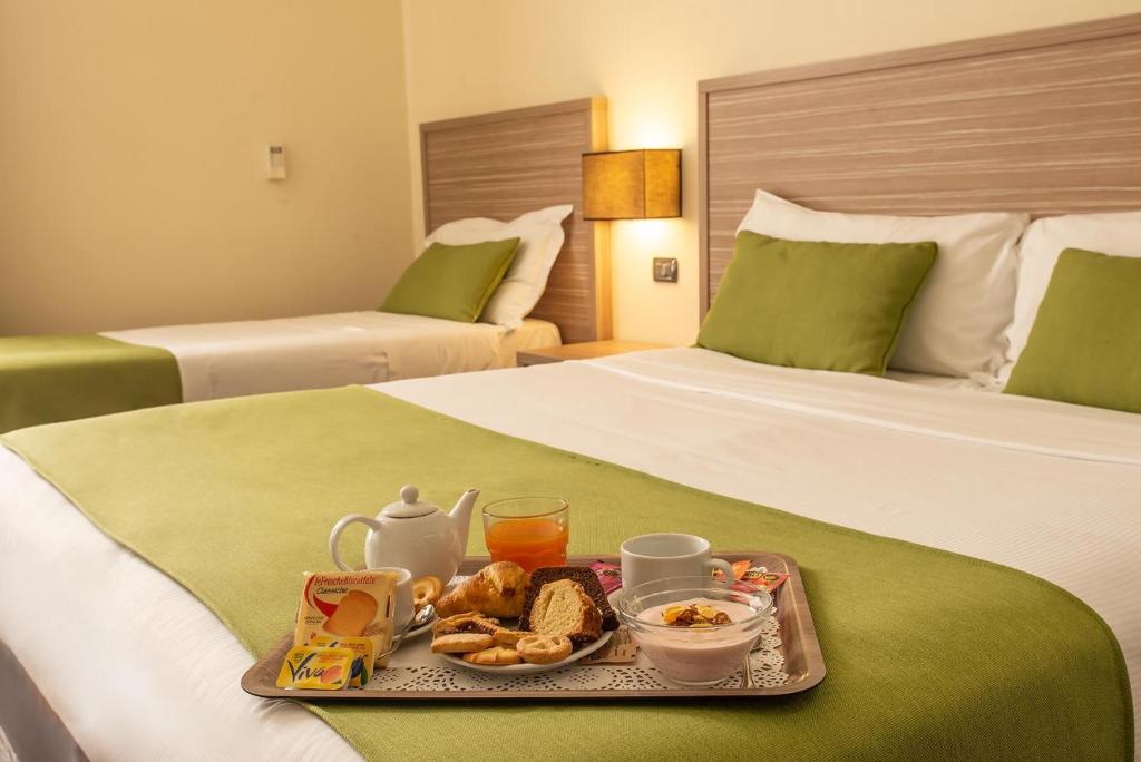 Postel nebo postele na pokoji v ubytování Hotel Roma Sud