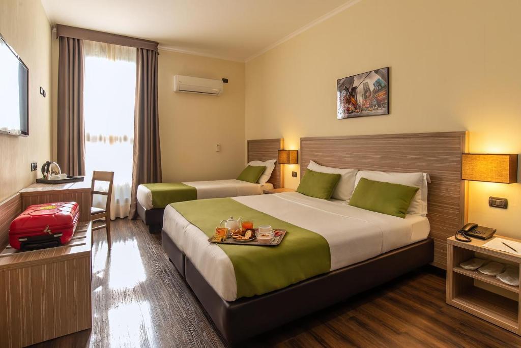 Postel nebo postele na pokoji v ubytování Hotel Roma Sud
