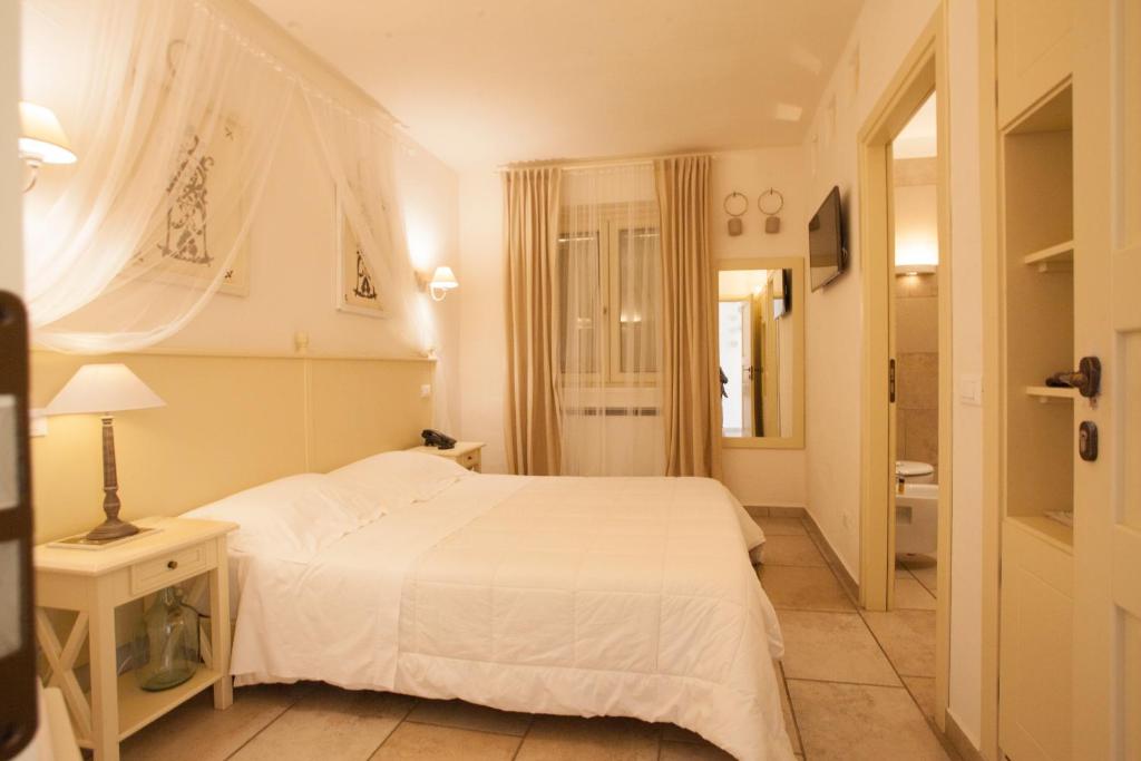 Postel nebo postele na pokoji v ubytování Relais in Contrada