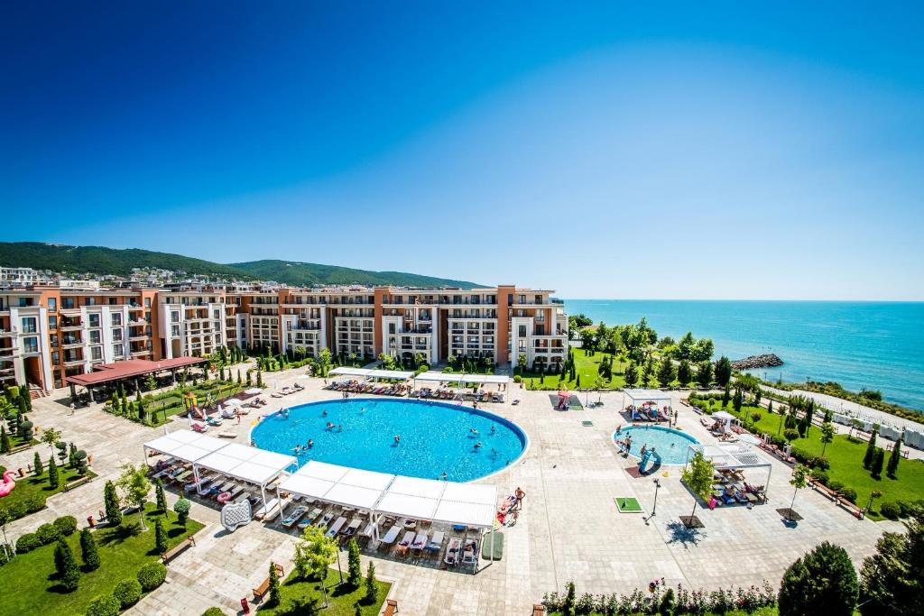 an aerial view of a resort with a swimming pool and the ocean at Prestige Sands Resort in Sunny Beach