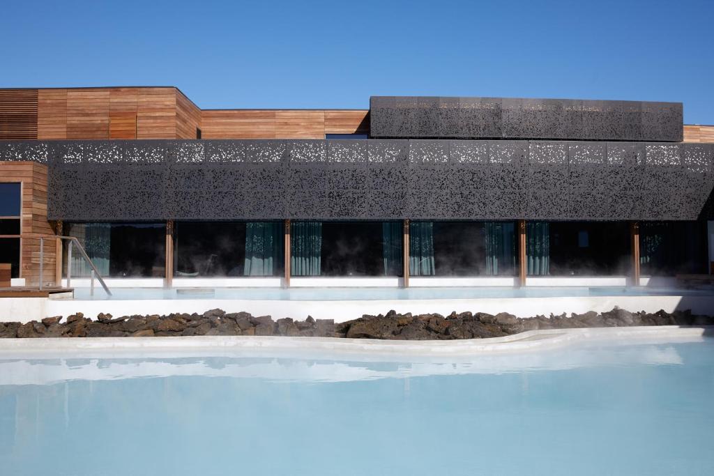 a building with a swimming pool in front of it at The Retreat at Blue Lagoon Iceland in Grindavík