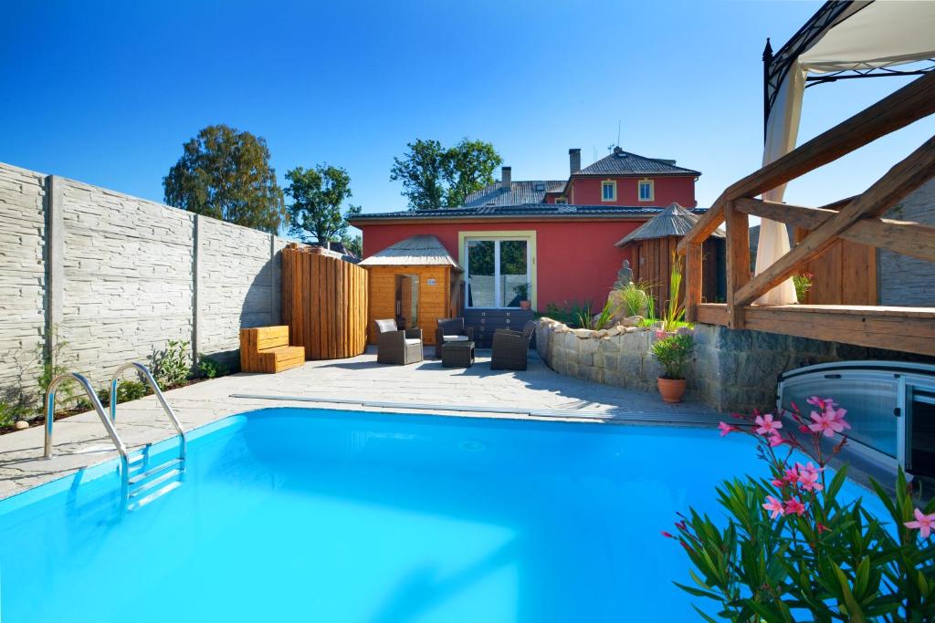 a swimming pool in the backyard of a house at Pytloun Wellness Travel Hotel in Liberec