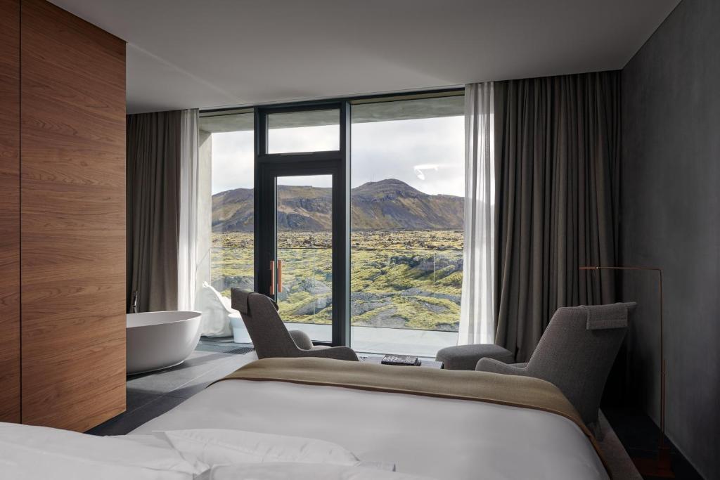 a hotel room with a bed and a large window at The Retreat at Blue Lagoon Iceland in Grindavík