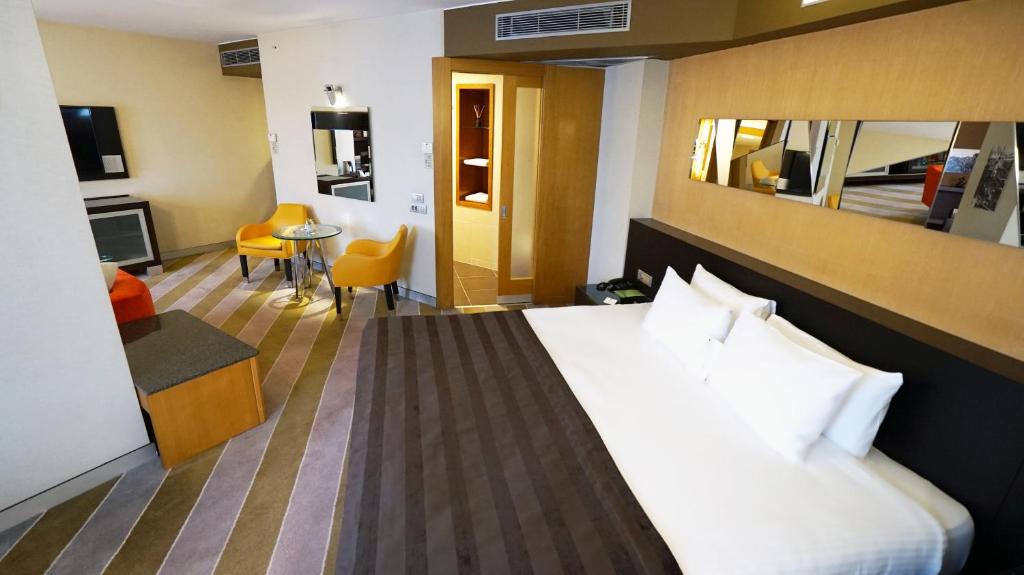 a hotel room with a large bed and a living room at Point Hotel Taksim in Istanbul