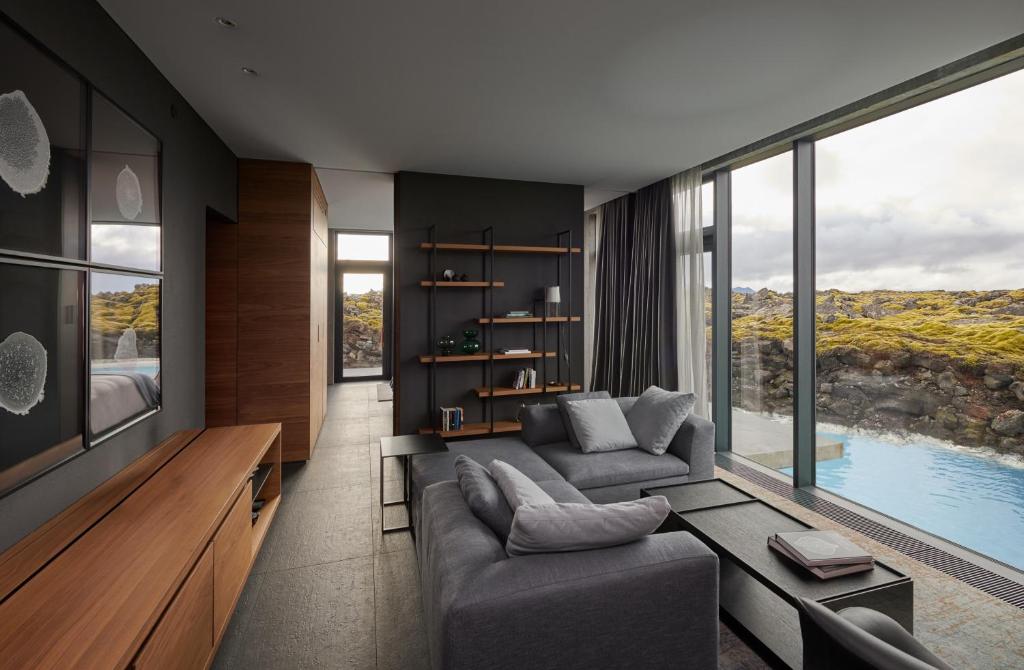 a living room with a couch and a large window at The Retreat at Blue Lagoon Iceland in Grindavík