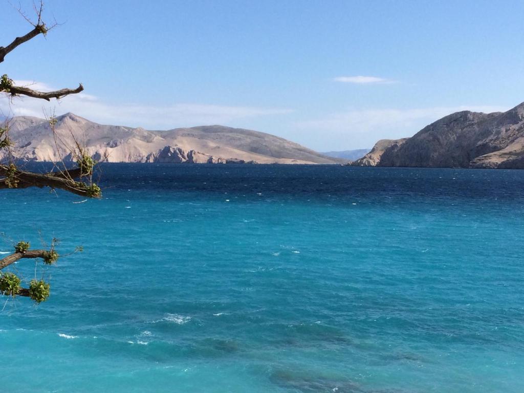 a large body of water with mountains in the background at Apartments Authentic Baska in Baška