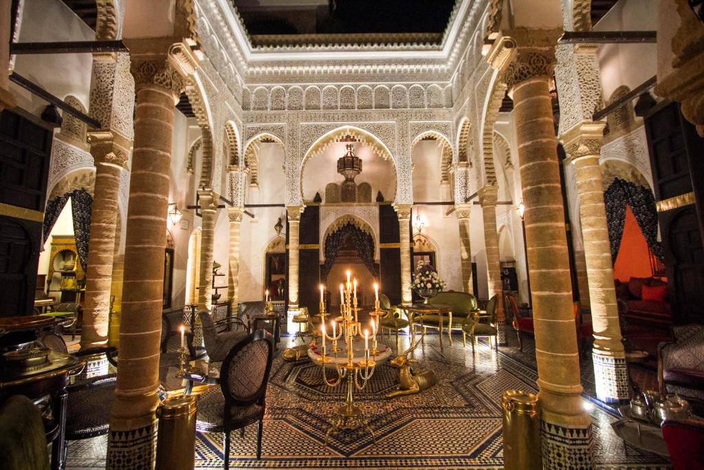 a large room with a chandelier in a building at Riad Thamayna in Salé