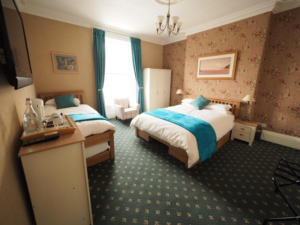 Postel nebo postele na pokoji v ubytování Cowrie Guest House
