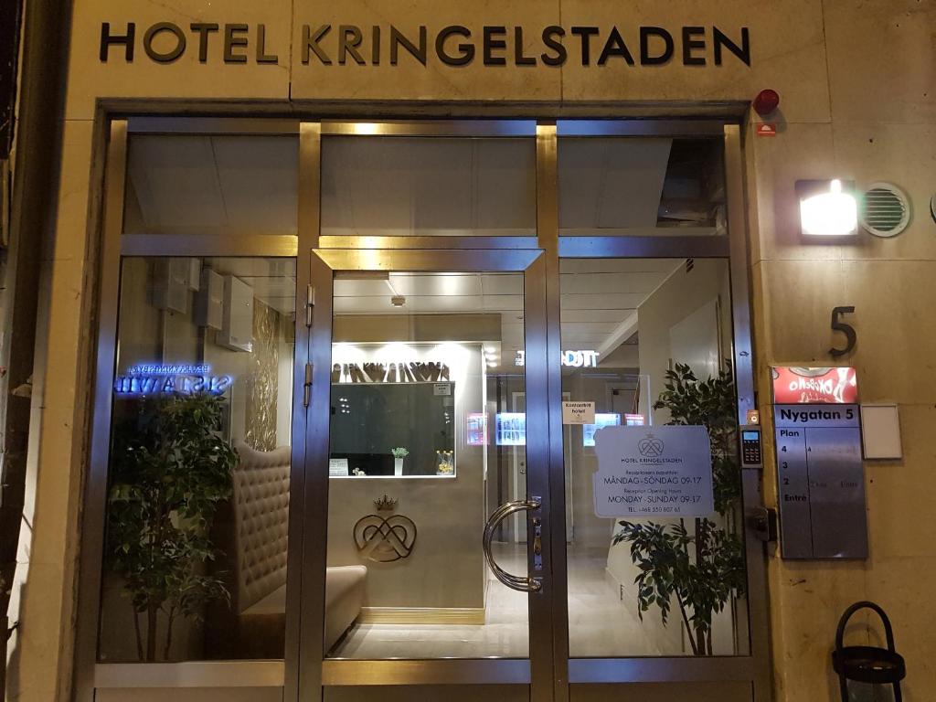 a hotel entrance with a sign on the door at Hotel Kringelstaden in Södertälje