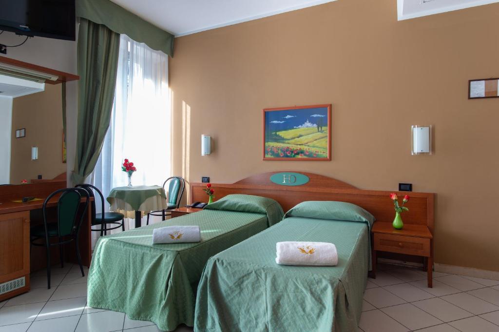 Posteľ alebo postele v izbe v ubytovaní Hotel Dorè