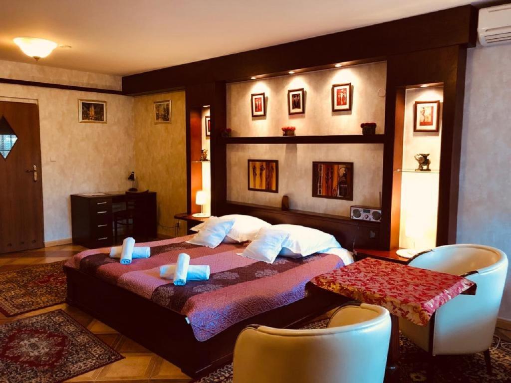 a bedroom with a bed with two candles on it at Black Jack "OZONOWANY" in Będzin