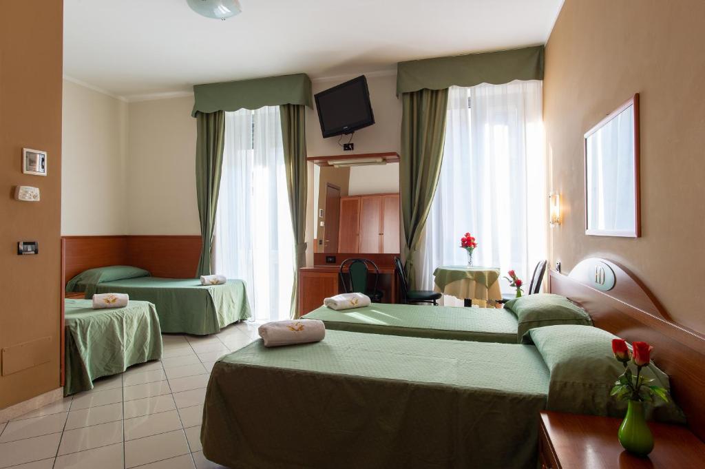 Posteľ alebo postele v izbe v ubytovaní Hotel Dorè