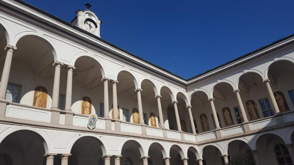 a building with a clock tower on top of it at Villa Terzaghi in Gorla Minore