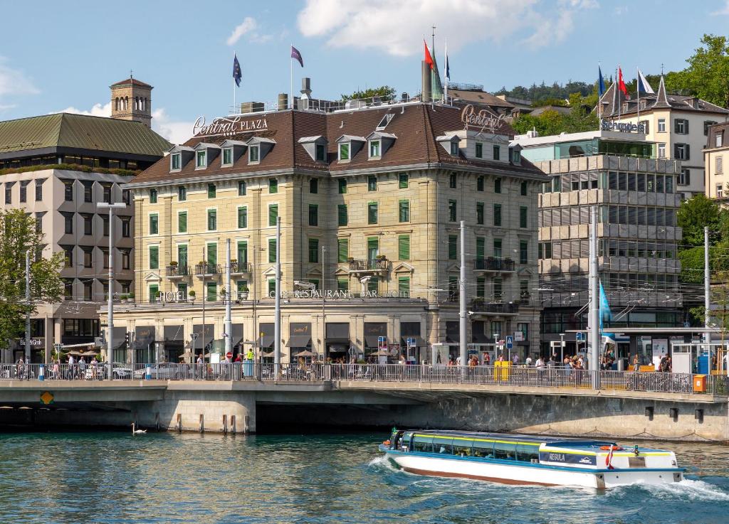 a boat in the water in front of a building at Central Plaza in Zurich