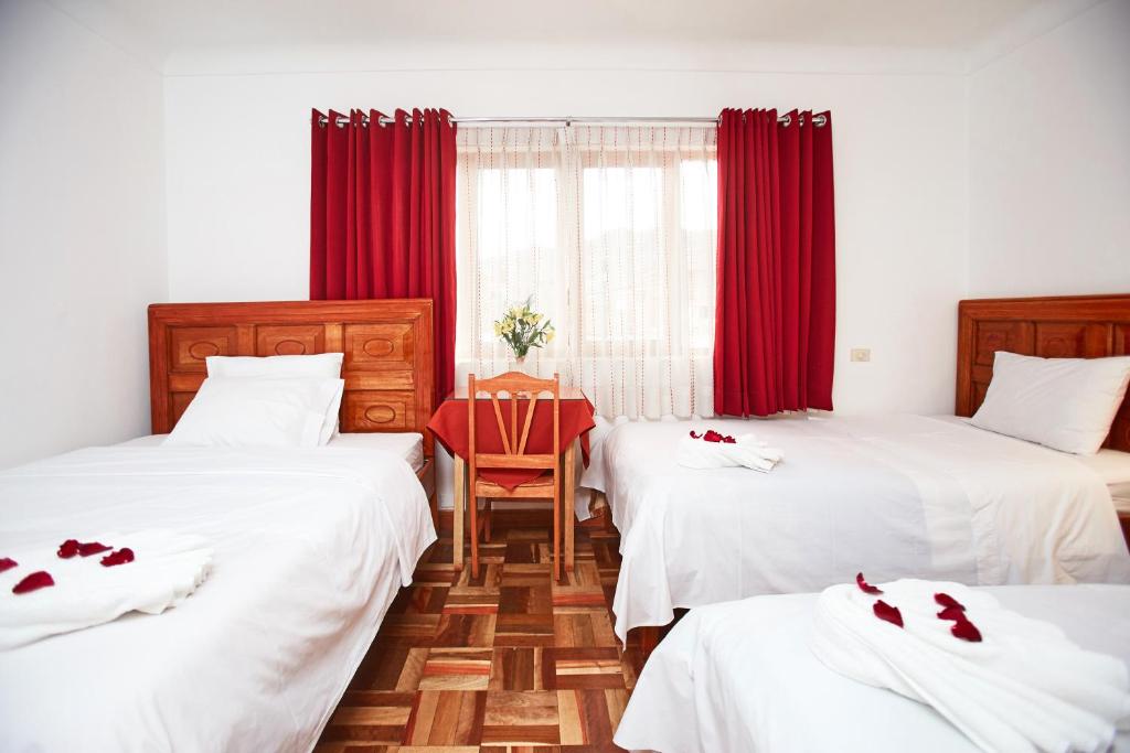 Postel nebo postele na pokoji v ubytování Hostal Danna Inn