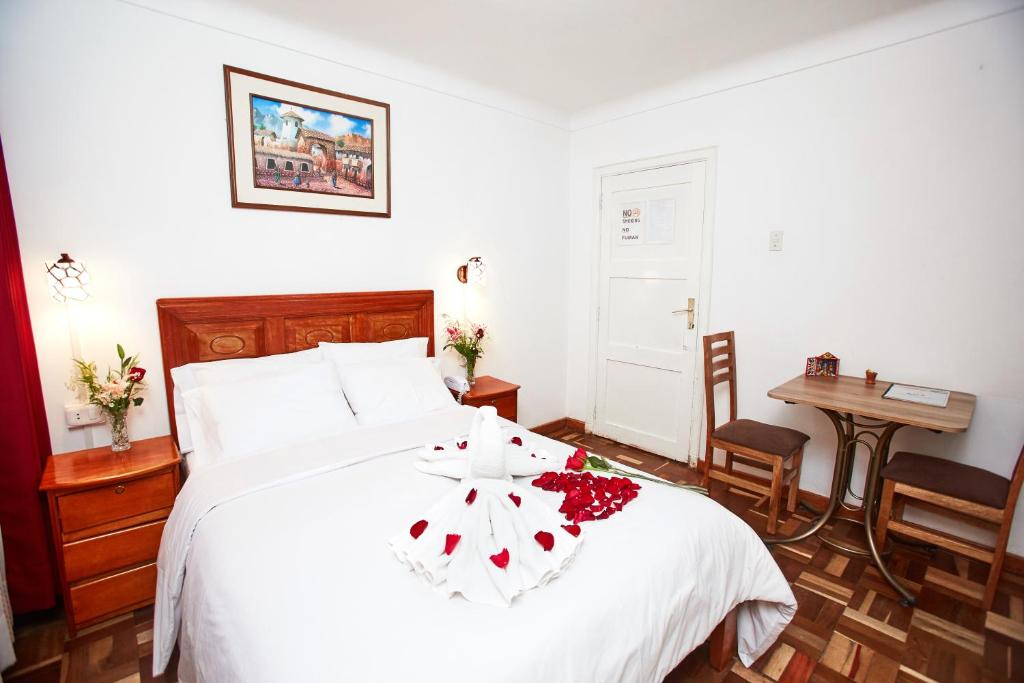 Postel nebo postele na pokoji v ubytování Hostal Danna Inn