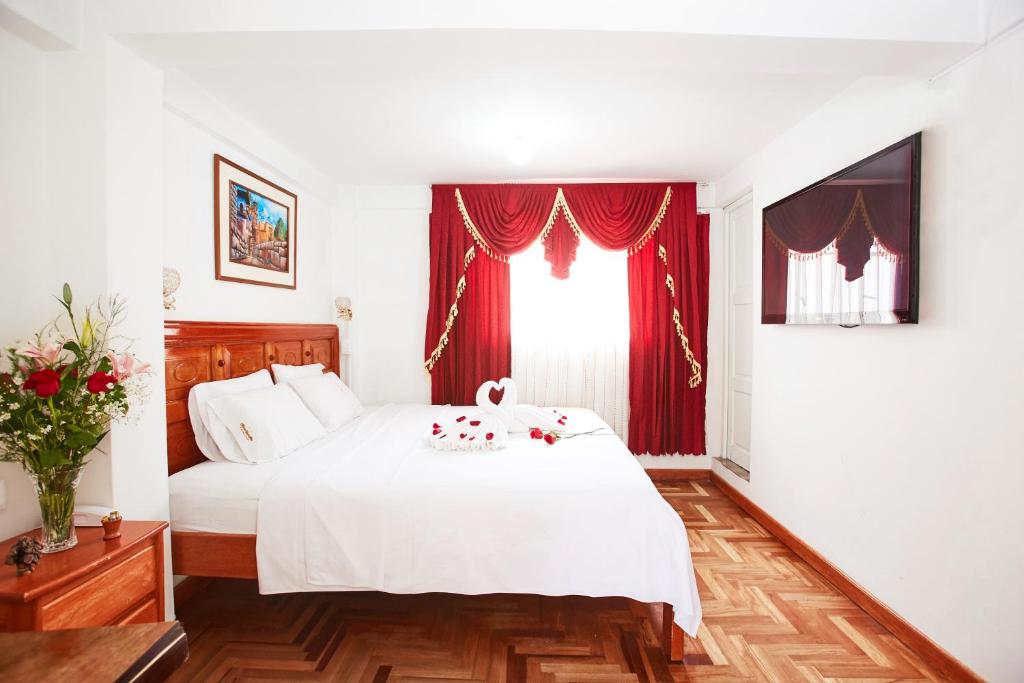 Postel nebo postele na pokoji v ubytování Hostal Danna Inn