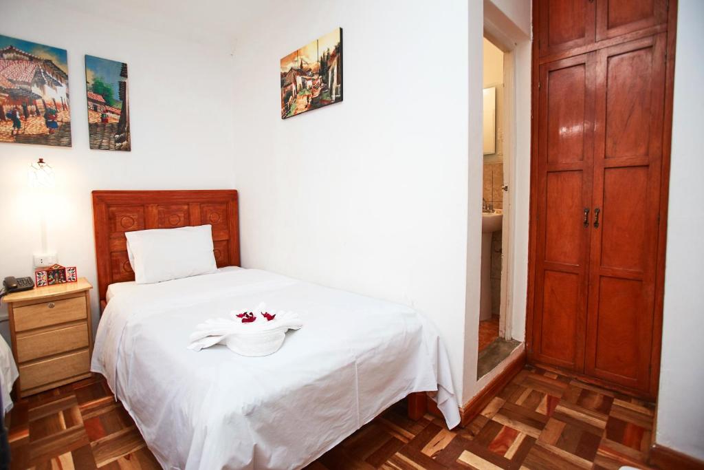 Postel nebo postele na pokoji v ubytování Hostal Danna Inn