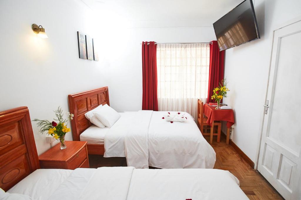 Postel nebo postele na pokoji v ubytování Hostal Danna Inn