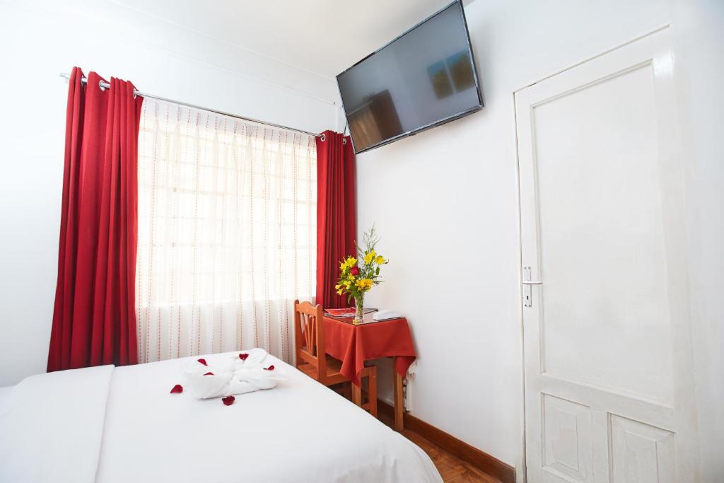 Postel nebo postele na pokoji v ubytování Hostal Danna Inn