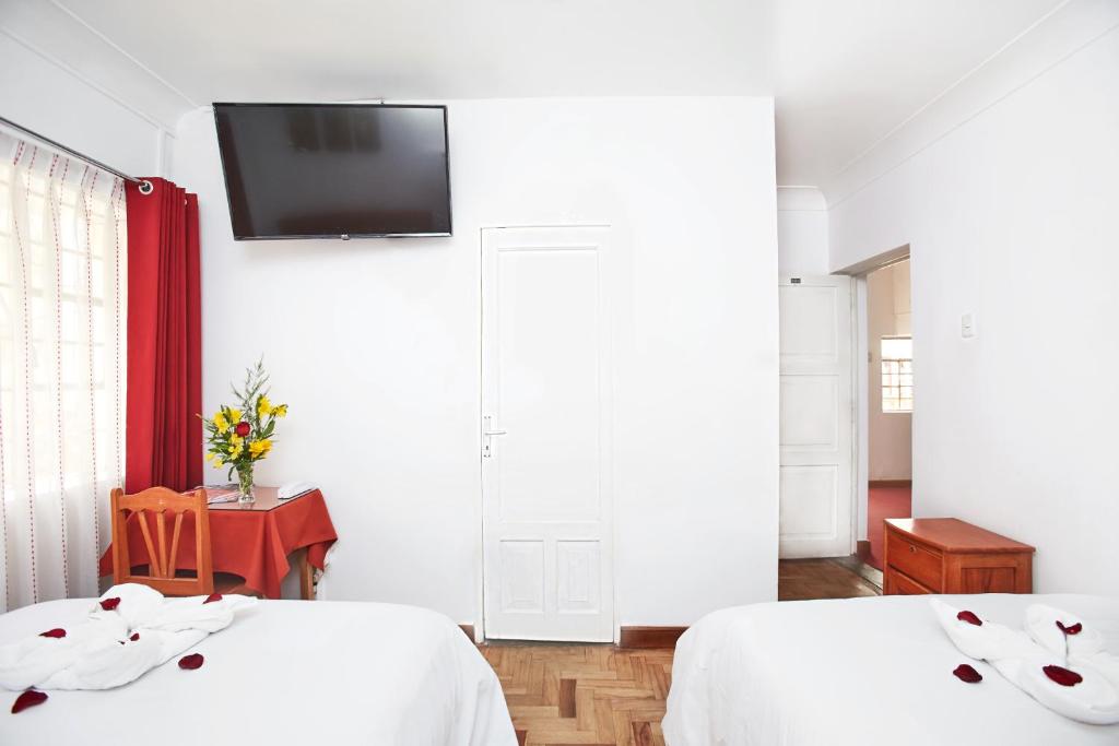 Postel nebo postele na pokoji v ubytování Hostal Danna Inn