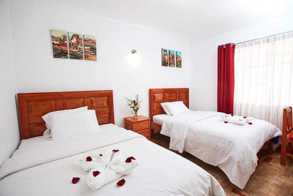 Postel nebo postele na pokoji v ubytování Hostal Danna Inn