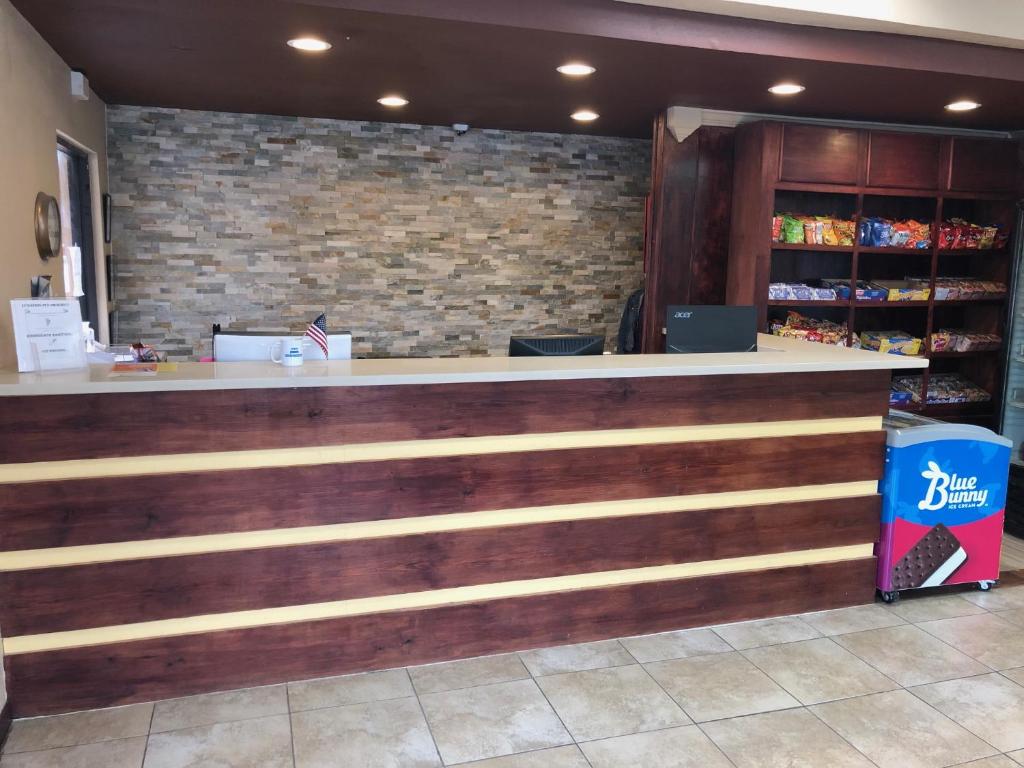 a bar in a store with a brick wall at Travel Inn & Suites in Humble