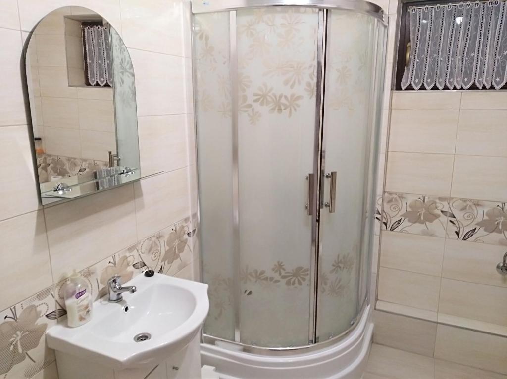a bathroom with a shower and a sink at Nocleg u Marysi in Iwonicz-Zdrój