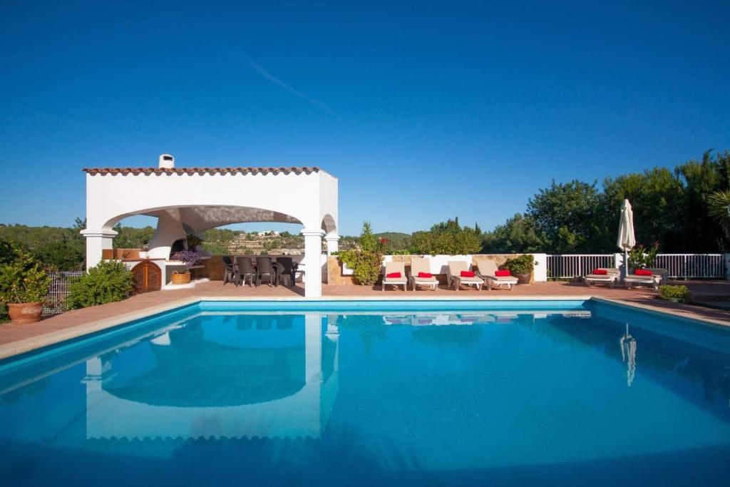 a swimming pool with a gazebo at CA NA PEPA in Sant Rafael de Sa Creu