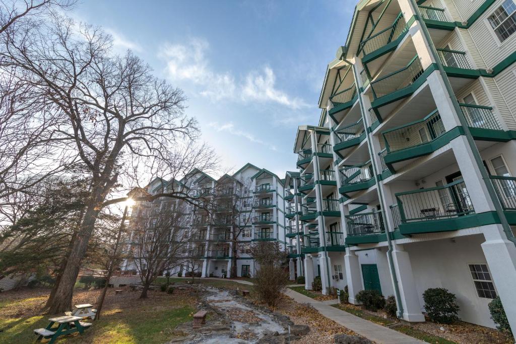 an apartment building with balconies and trees at Carriage Place by Capital Vacations in Branson