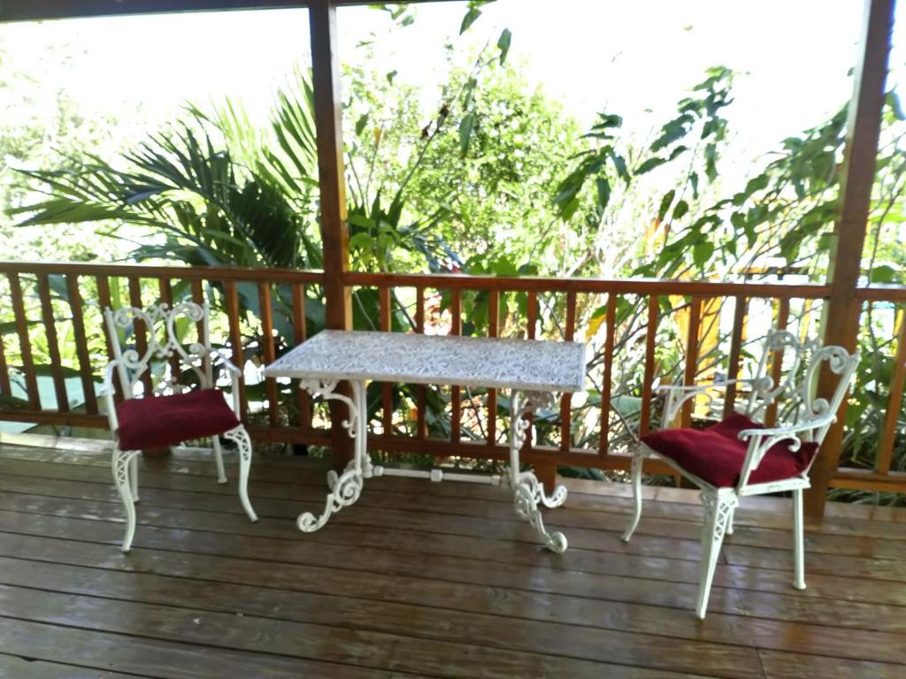 two chairs and a table on a deck at The Pool House in Saint Philip