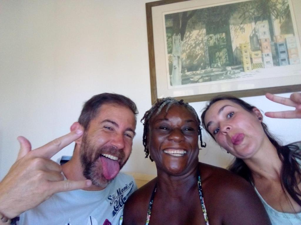 a man and two women posing for a picture with their tongue at The Pool House in Saint Philip