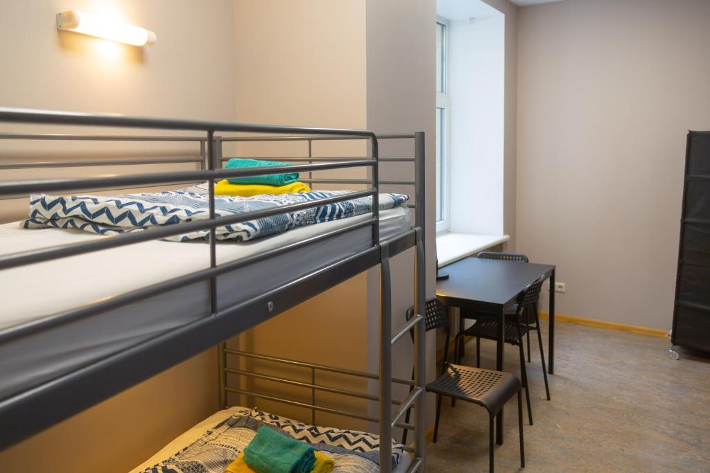 a room with two bunk beds and a desk at Liberty Airy in Rīga