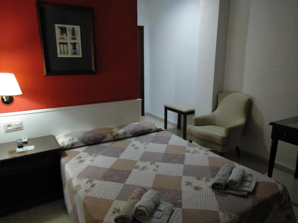 Posteľ alebo postele v izbe v ubytovaní Hotel Nuevo Ara