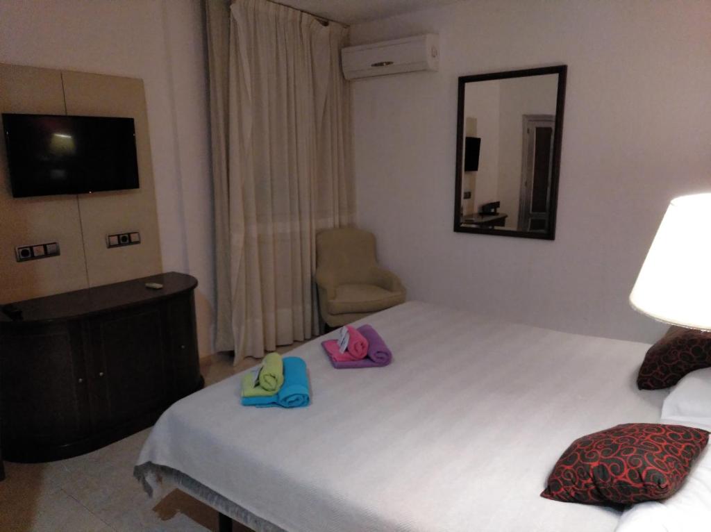 Posteľ alebo postele v izbe v ubytovaní Hotel Nuevo Ara