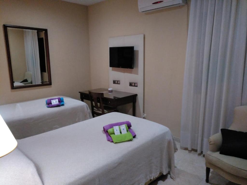 Posteľ alebo postele v izbe v ubytovaní Hotel Nuevo Ara