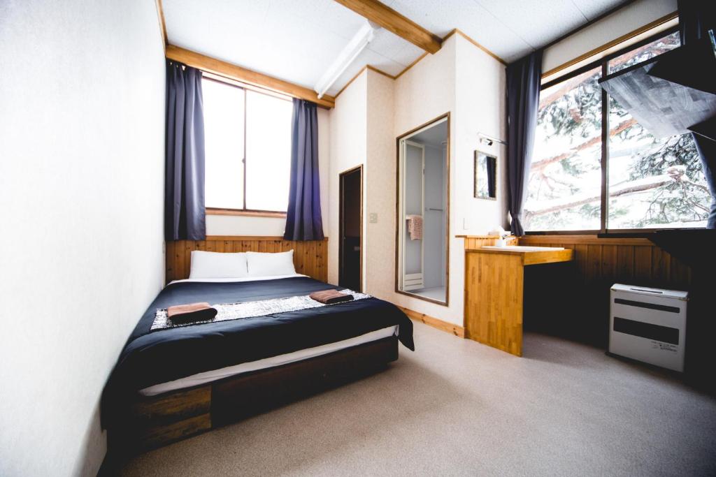Postel nebo postele na pokoji v ubytování Hakuba Cortina Lodge