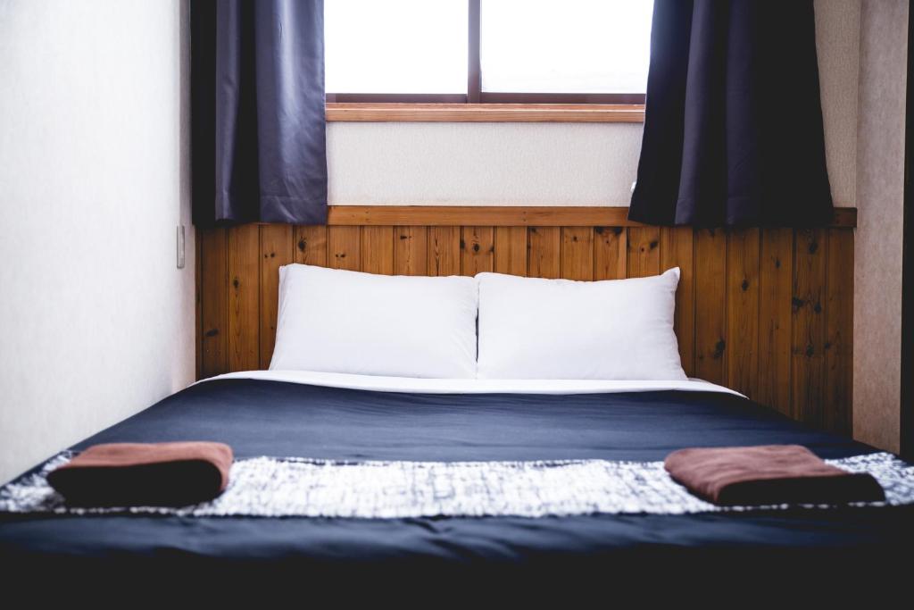 Postel nebo postele na pokoji v ubytování Hakuba Cortina Lodge