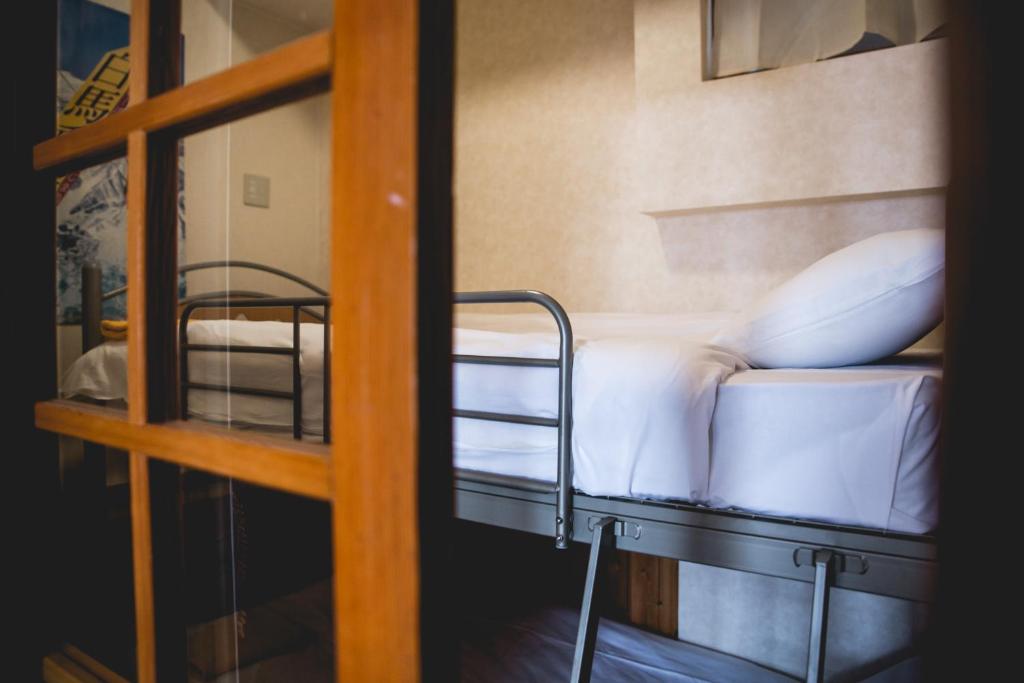 Postel nebo postele na pokoji v ubytování Hakuba Cortina Lodge