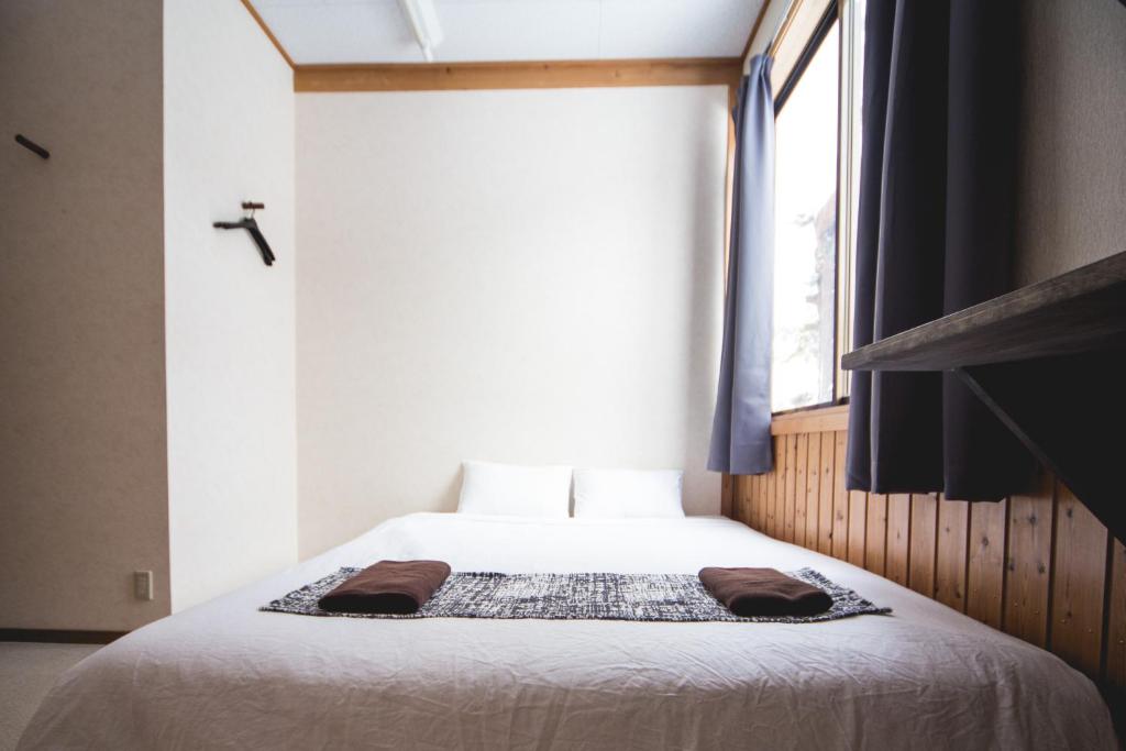 Postel nebo postele na pokoji v ubytování Hakuba Cortina Lodge