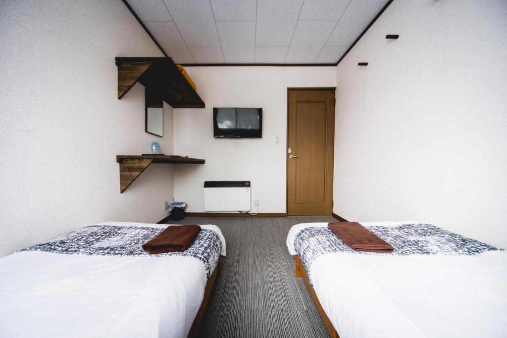 Postel nebo postele na pokoji v ubytování Hakuba Cortina Lodge